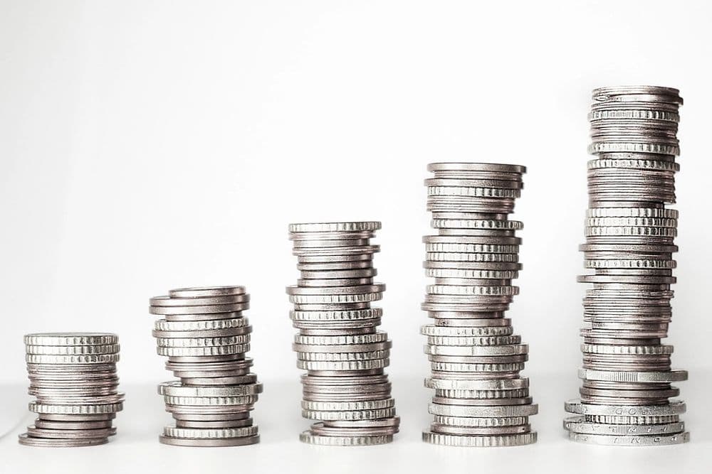 Stacks of coins rising in height from left to right